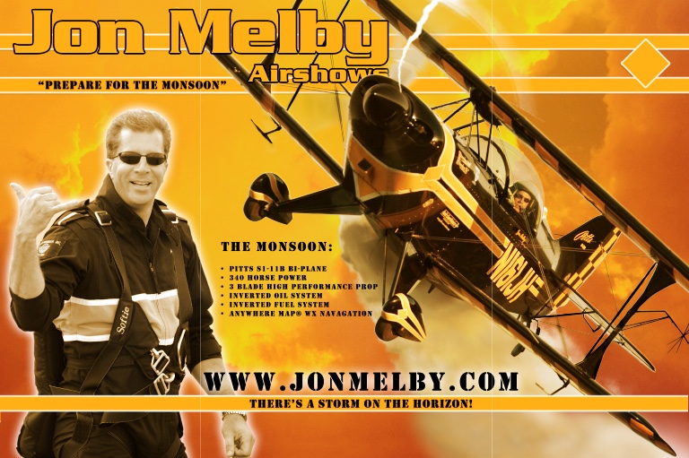 Trade show booth signage: the pilot in flight suit at left, the biplane banking across an orange storm sky, an aircraft specification list, and the web address across the foot.